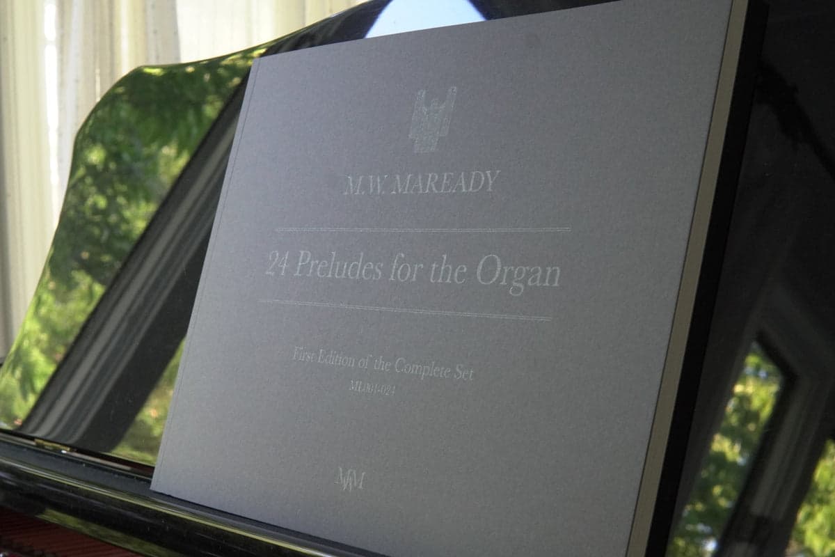 The grey cover of 24 Preludes for the Organ on a music desk